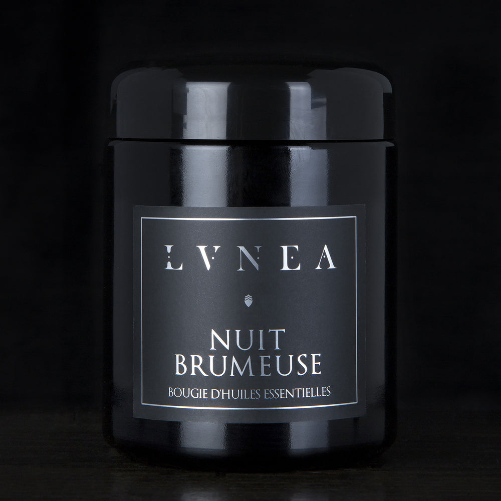 LVNEA’s Nuit Brumeuse candle housed in a resealable 8 ounce black glass jar on a black background