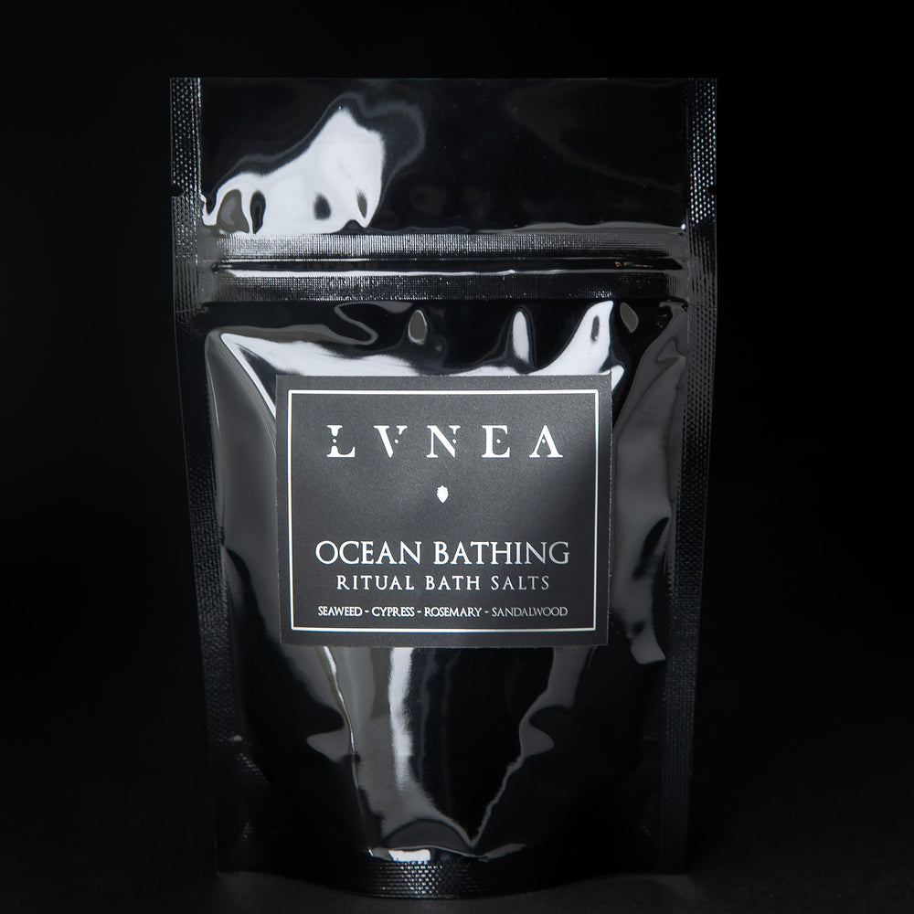 4oz black resealable pouch of LVNEA's Ocean Bathing bath salts standing on black background