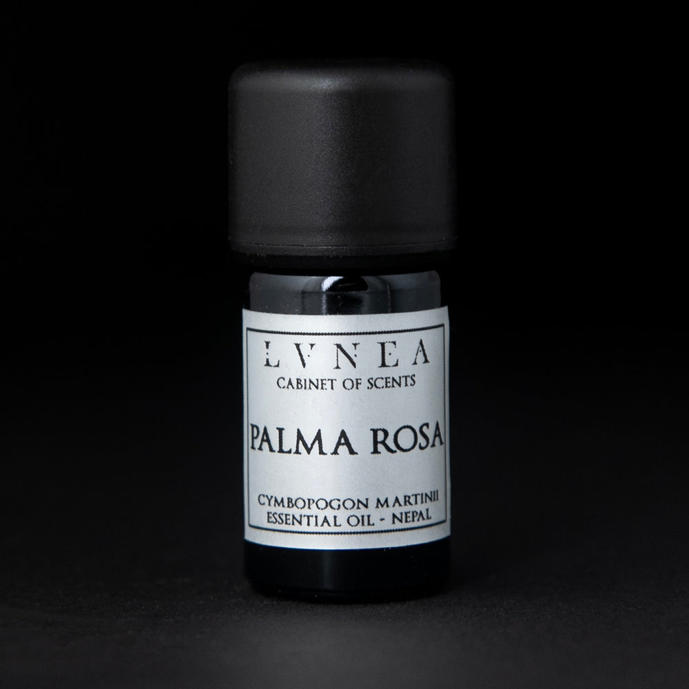 5ml black glass bottle of LVNEA's palma rosa essential oil on black background. The label on the bottle is silver.