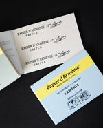 Papier d'Arménie booklet open to reveal the perforated sheets of incense paper.