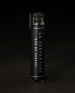 2ml glass sample vial of LVNEA's La Serpentine natural perfume on black background