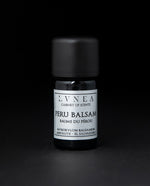 5ml black glass bottle of LVNEA's peru balsam absolute on black background. The label on the bottle is silver.