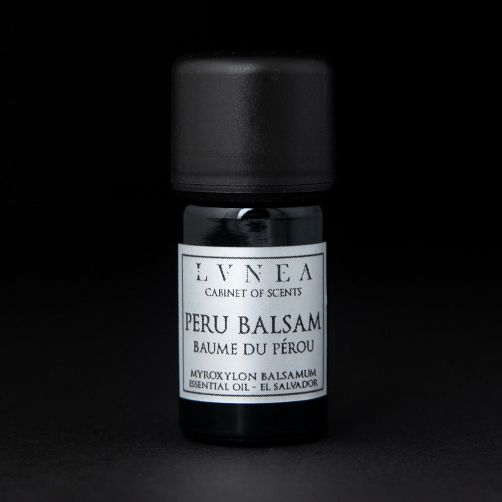 5ml black glass bottle of LVNEA's peru balsam essential oil on black background. The label on the bottle is silver.
