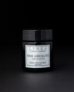 Black glass jar of LVNEA's pine absolute on black background