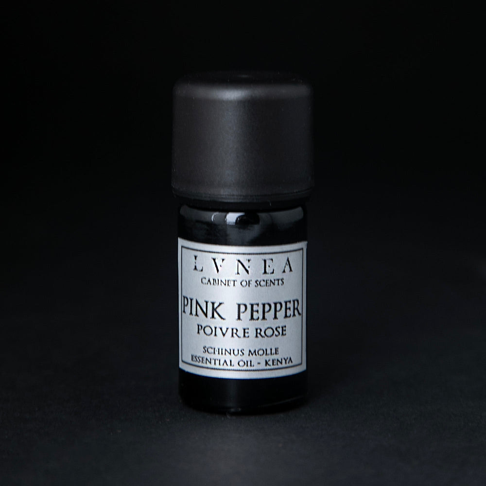 5ml black glass bottle of LVNEA's pink pepper essential oil on black background. The label on the bottle is silver.