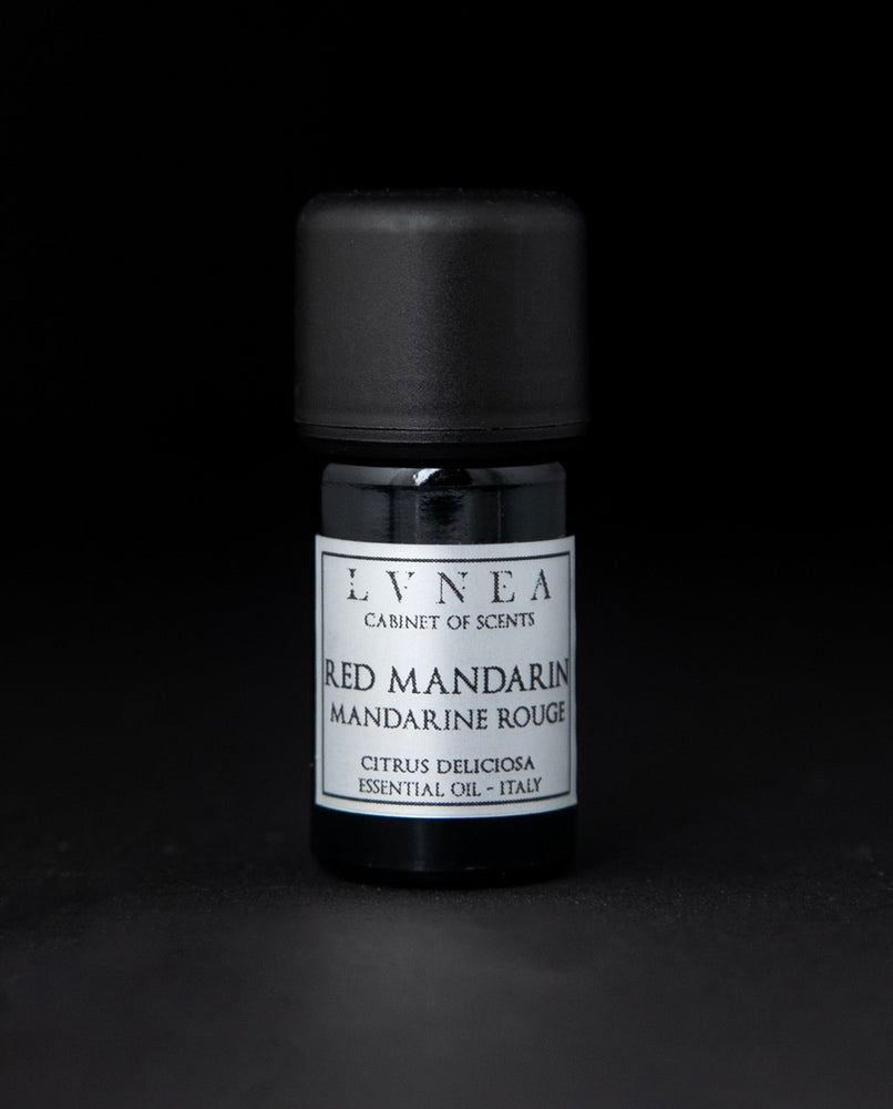 5ml black glass bottle of LVNEA's red mandarin essential oil on black background. The label on the bottle is silver.