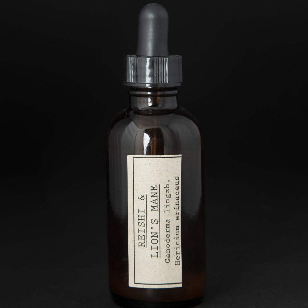 Amber glass bottle with dropper top filled with blueberryjams' "Reishi & Lion's Mane" herbal tincture