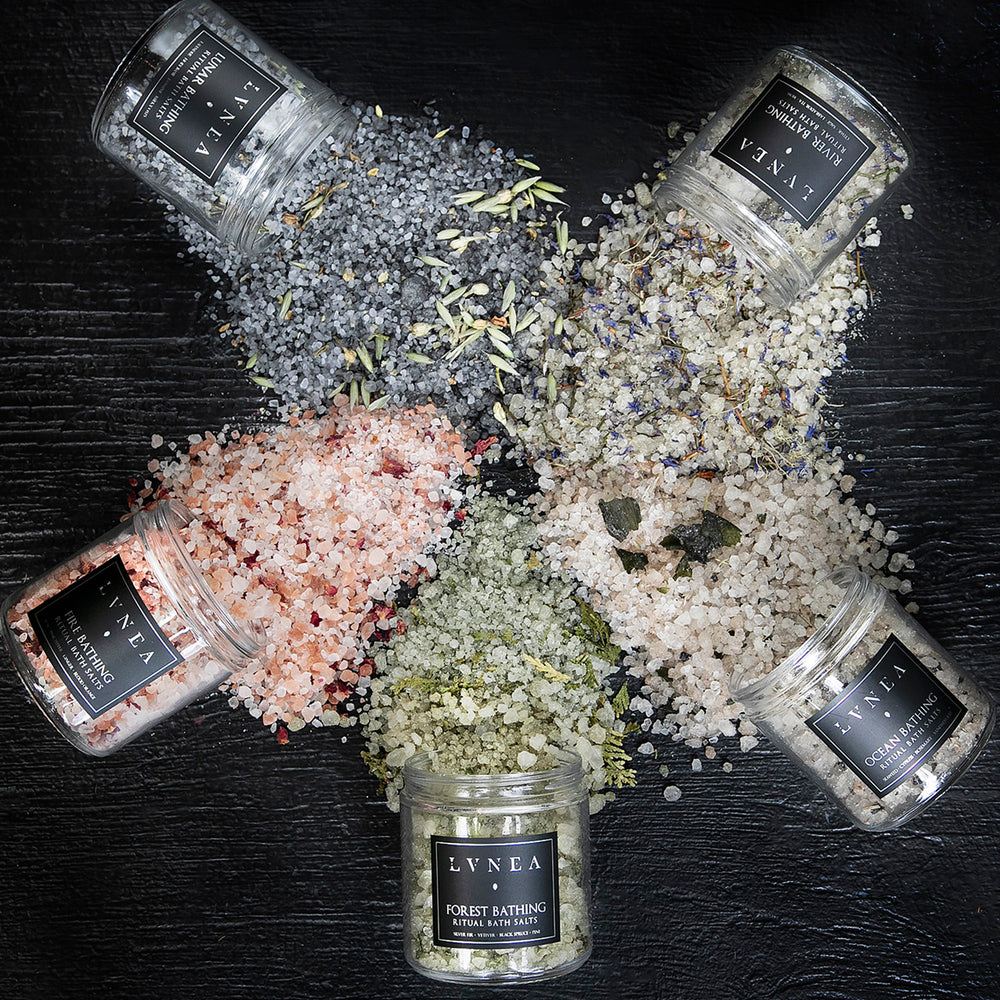 
                      
                        All five of LVNEA's elemental ritual bath salts arranged in a circle and spilling over with colourful salt blends.
                      
                    