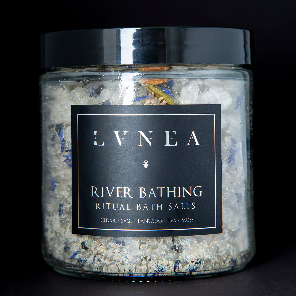 A clear 16 ounce jar filled with LVNEA's River Bathing bath salts on black background