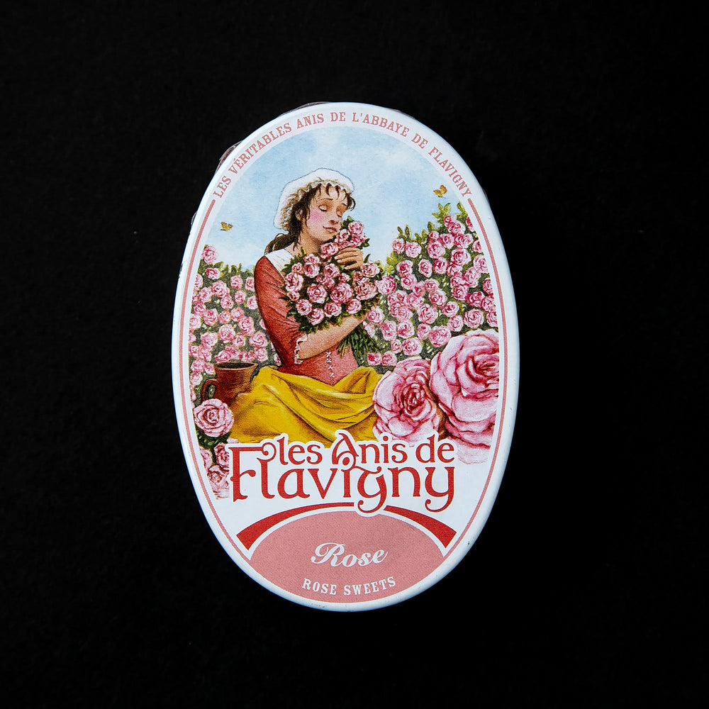 tin of rose flavoured bonbons with image of a woman in a rose field on the top