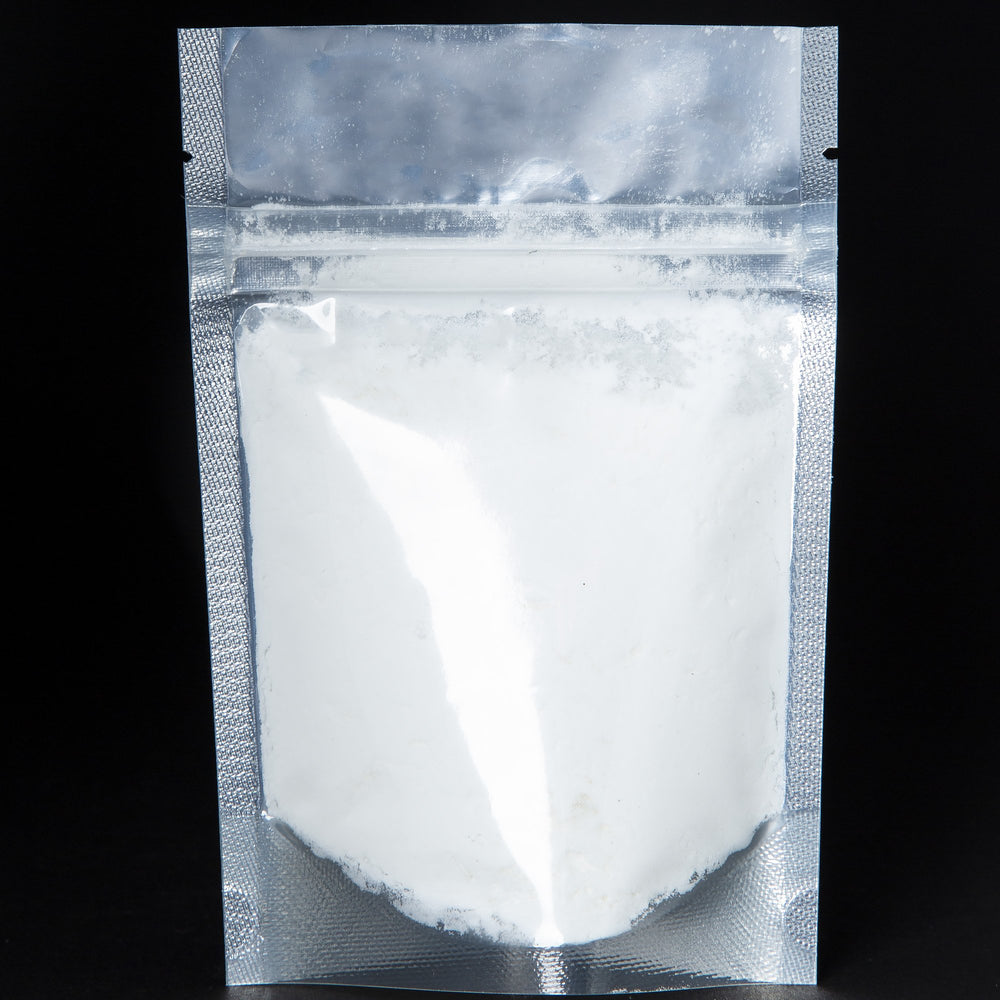 A black 2 oz resealable pouch filled LVNEA's Rose & Bois vegan coconut milk based bath soak.