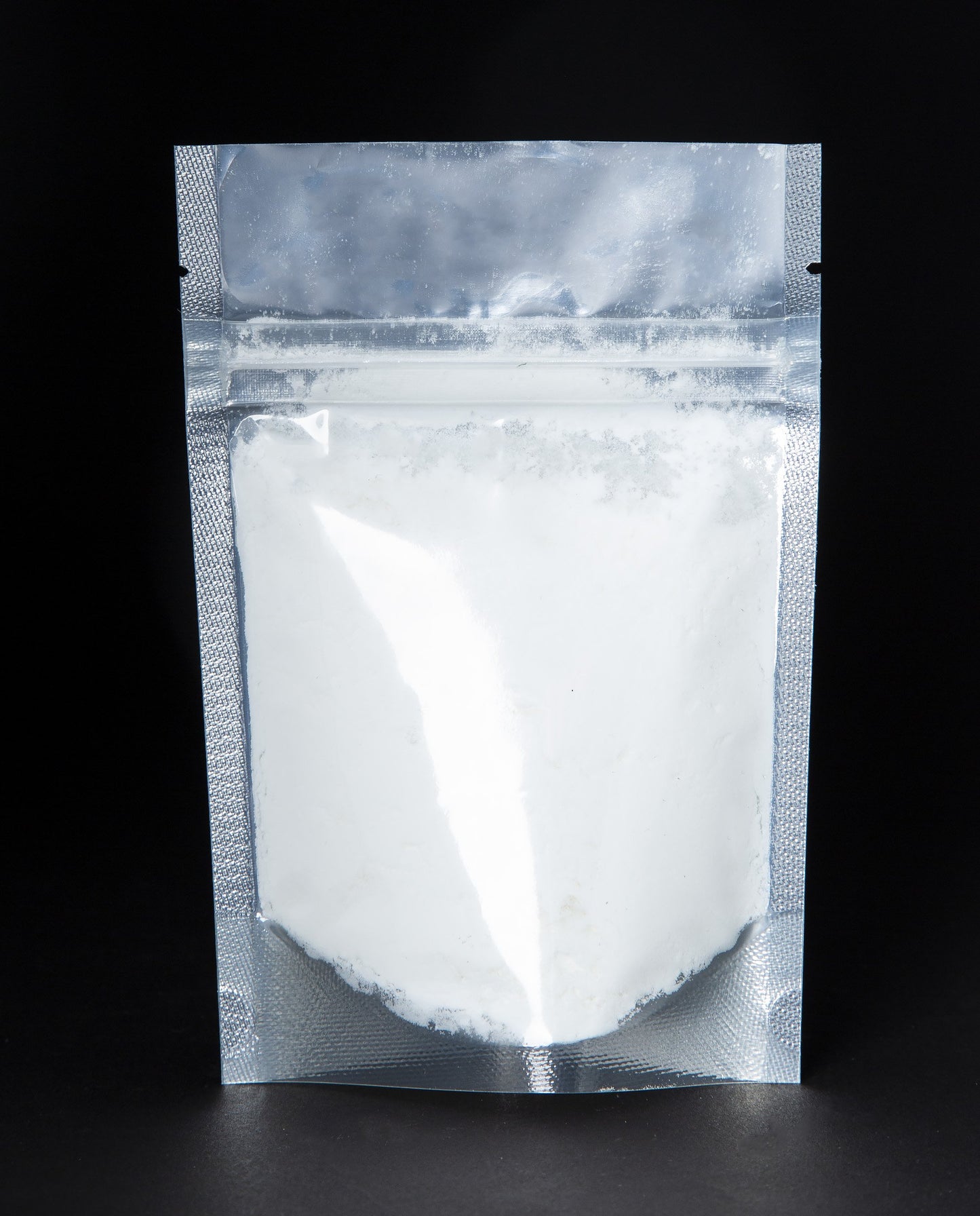A black 2 oz resealable pouch filled LVNEA's Rose & Bois vegan coconut milk based bath soak.