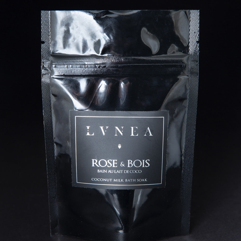A black 2 oz resealable pouch filled LVNEA's Rose & Bois vegan coconut milk based bath soak.