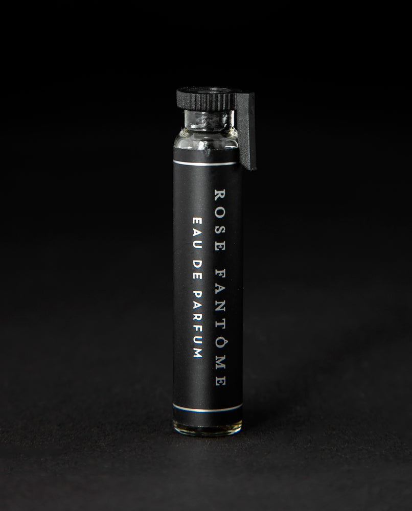2ml glass sample vial of LVNEA's Rose Fantôme natural perfume on black background