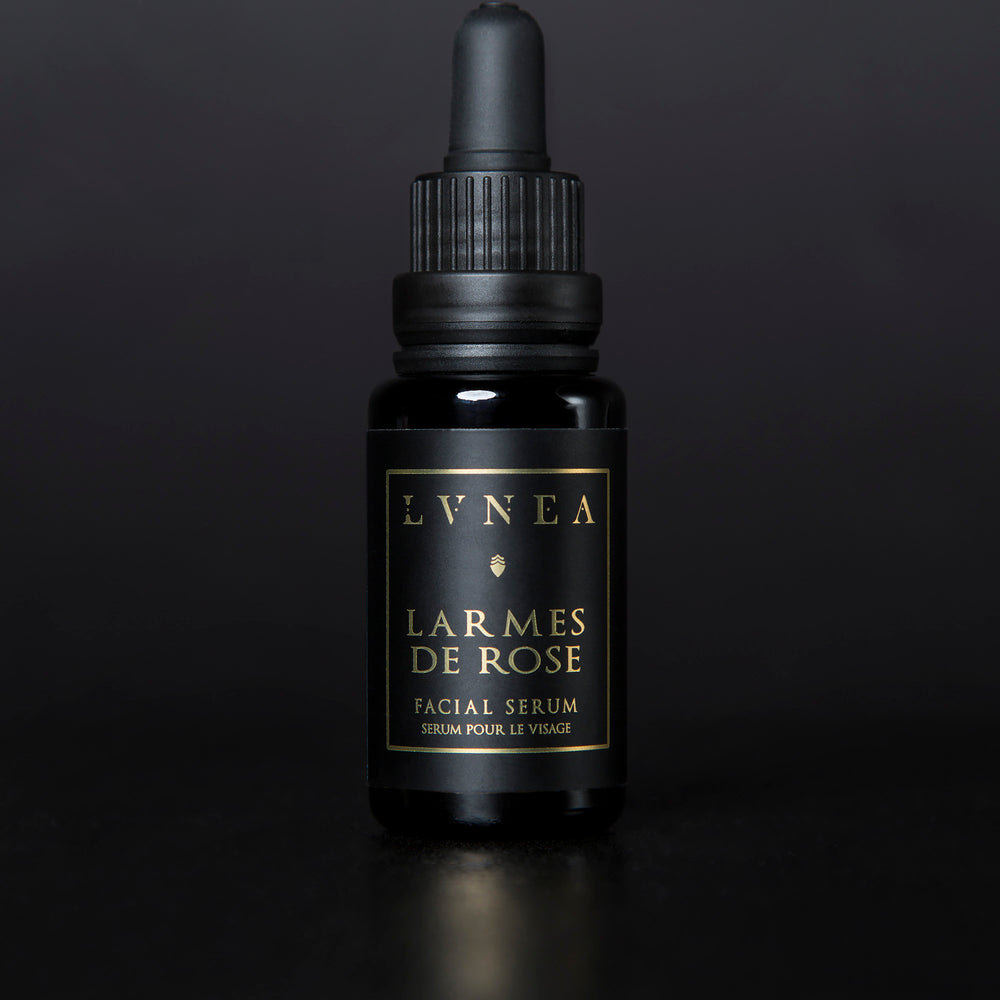 LVNEA's Larmes de Rose facial serum housed in a 20ml black glass bottle with dropper top on a black background.