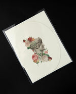 white oval-shaped greeting card with a vintage Victorian-style illustration of a marble bust surrounded by roses