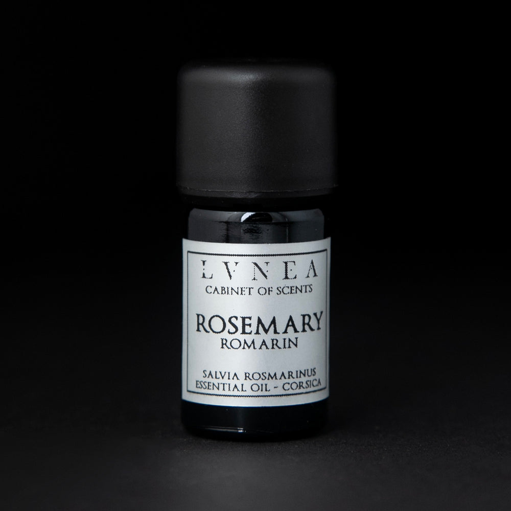 5ml black glass botttle of LVNEA's rosemary essential oil on black background. The label on the bottle is silver.