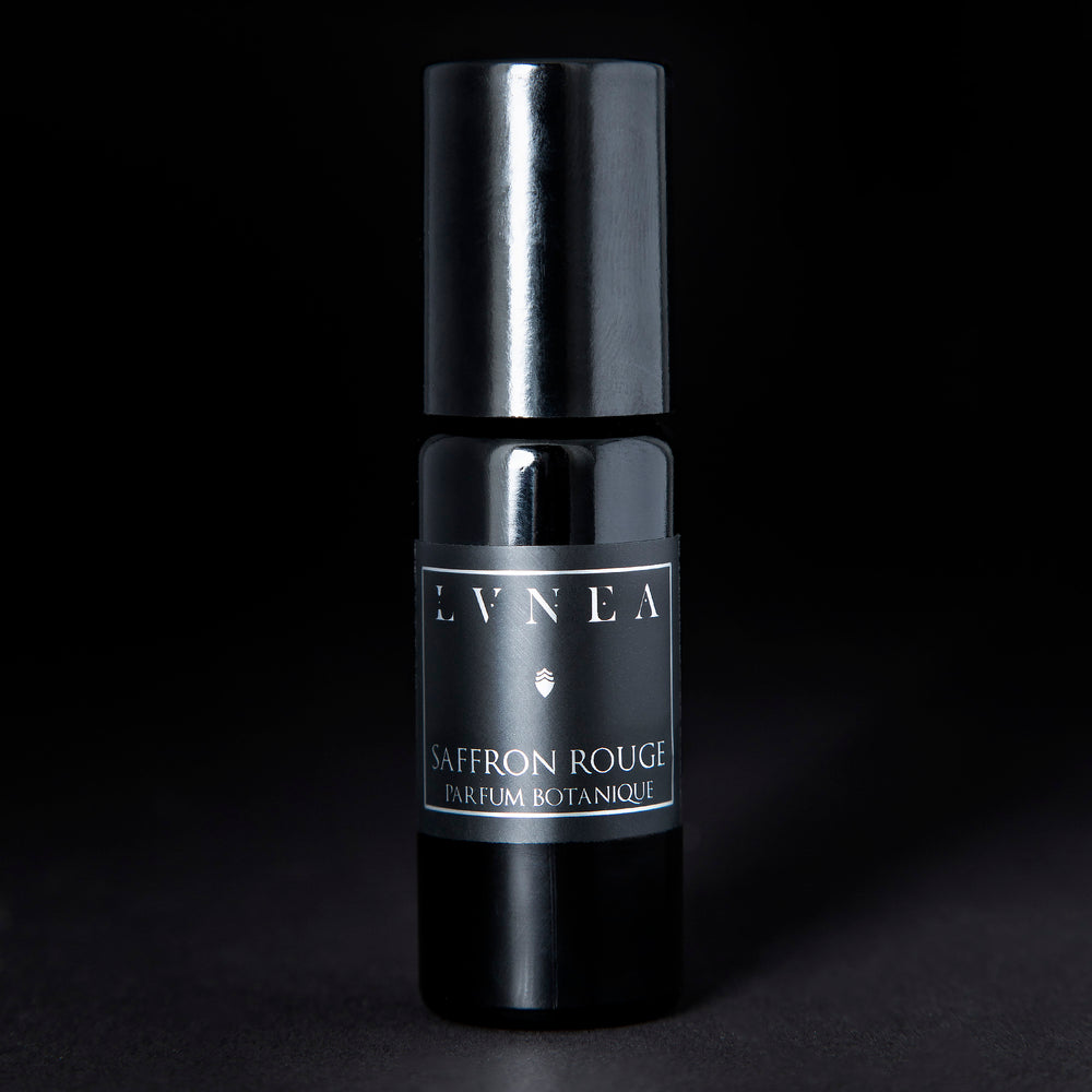 10ml black glass bottle of LVNEA's Saffron Rouge natural roll on perfume oil on black background