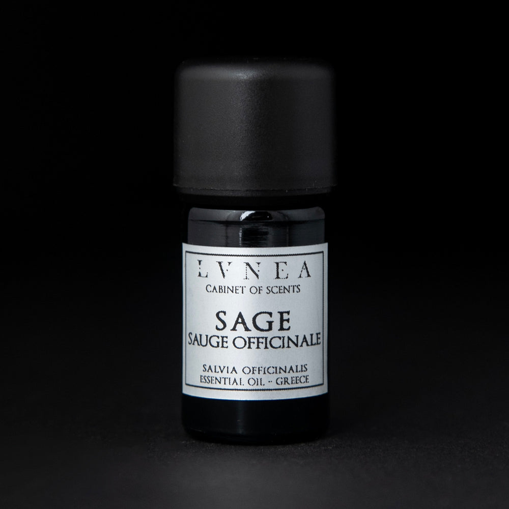 5ml black glass botttle of LVNEA's sage essentail oil on black background. The label on the bottle is silver.