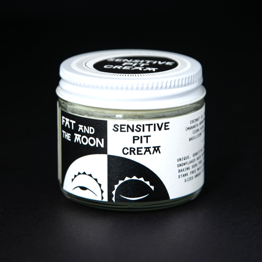 Clear glass jar of Fat and The Moon's natural deodorant cream. There is an illustration of a half moon on the label.