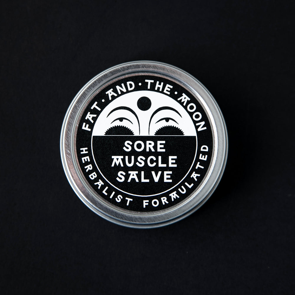 
                      
                        2oz metal tin of Fat and the Moon's "Sore Muscle Salve" seen from above. The label is black and white with an illustration of a half moon on it.
                      
                    