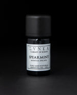 5ml black glass bottle of LVNEA's spearmint essential oil on black background. The label on the bottle is silver.