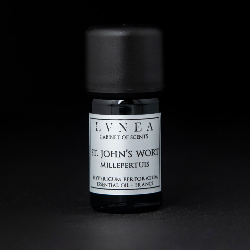 5ml black glass bottle of LVNEA's St. John's Wort essential oil on black background. The label on the bottle is silver.