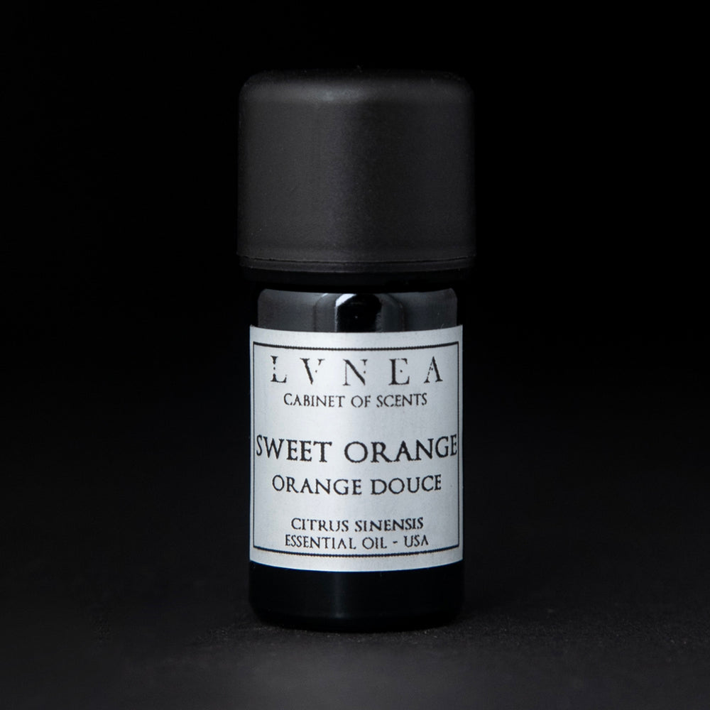 5ml black glass bottle of LVNEA's sweet orange essential oil on black background. The bottle has a silver label.