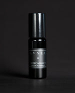 10ml black glass bottle of LVNEA's Tasseomancy natural roll on perfume on black background