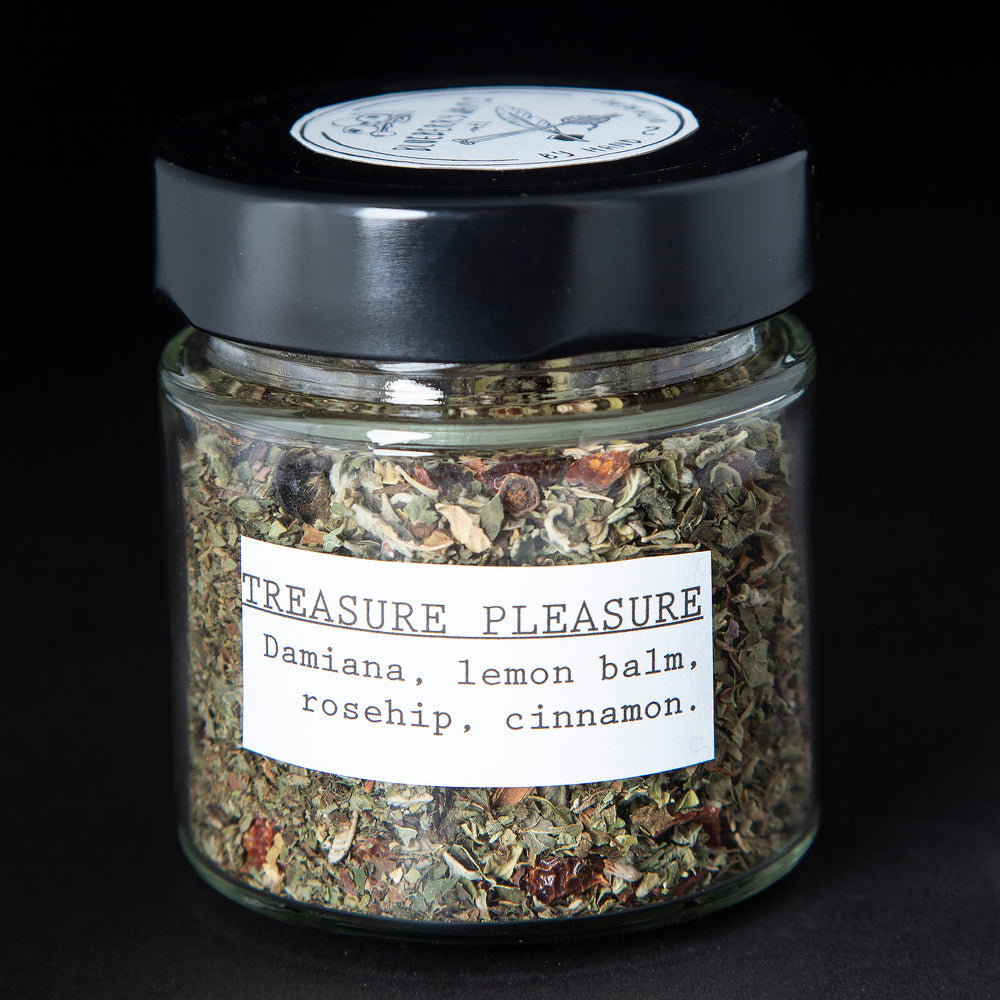 Clear glass jar of blueberryjams' "Treasure Pleasure" herbal tea blend.