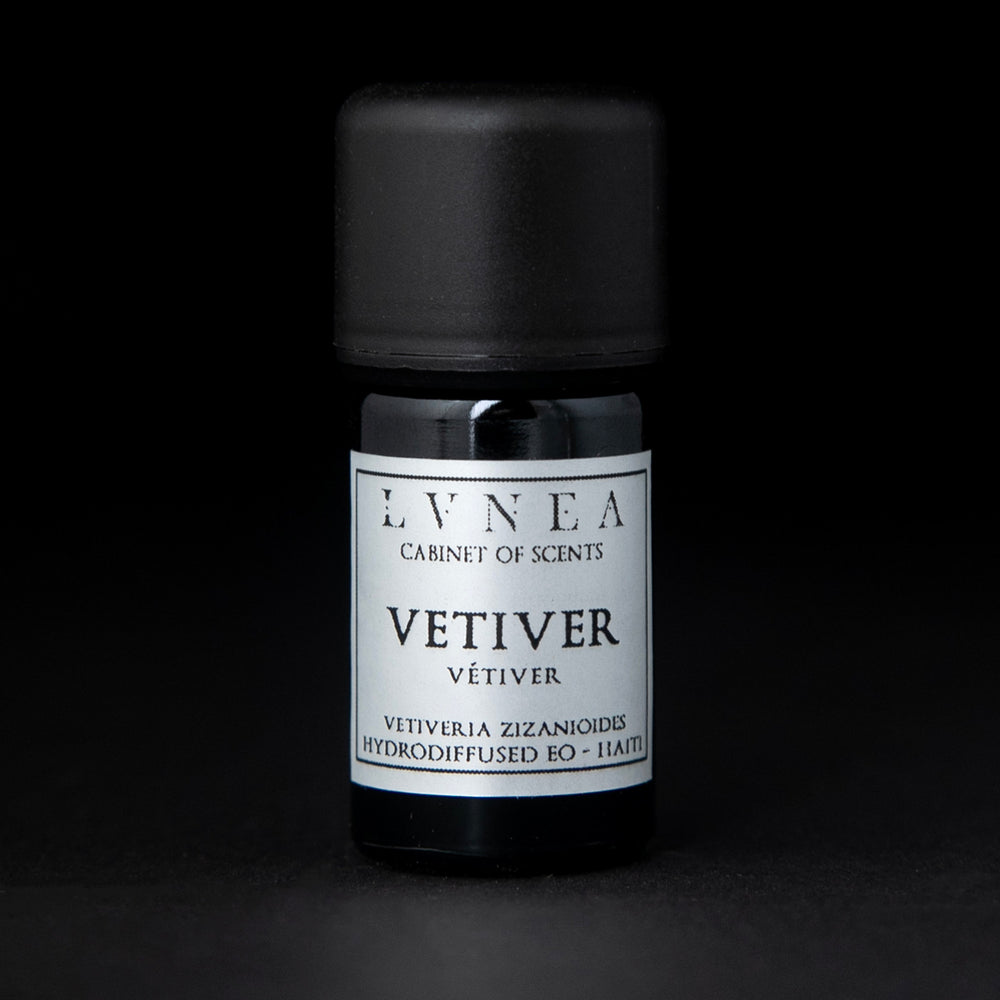 5ml black glass bottle of LVNEA's vetiver essential oil on black background. The label on the bottle is silver.