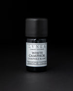 5ml black glass bottle of LVNEA's white camphor essential oil on black background.